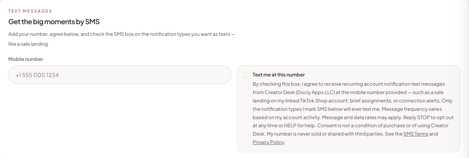 The Creator Desk Notification Preferences page: mobile number field, unchecked consent checkbox labeled 'Text me at this number', and disclosure text stating message frequency varies, message and data rates may apply, reply STOP to opt out or HELP for help